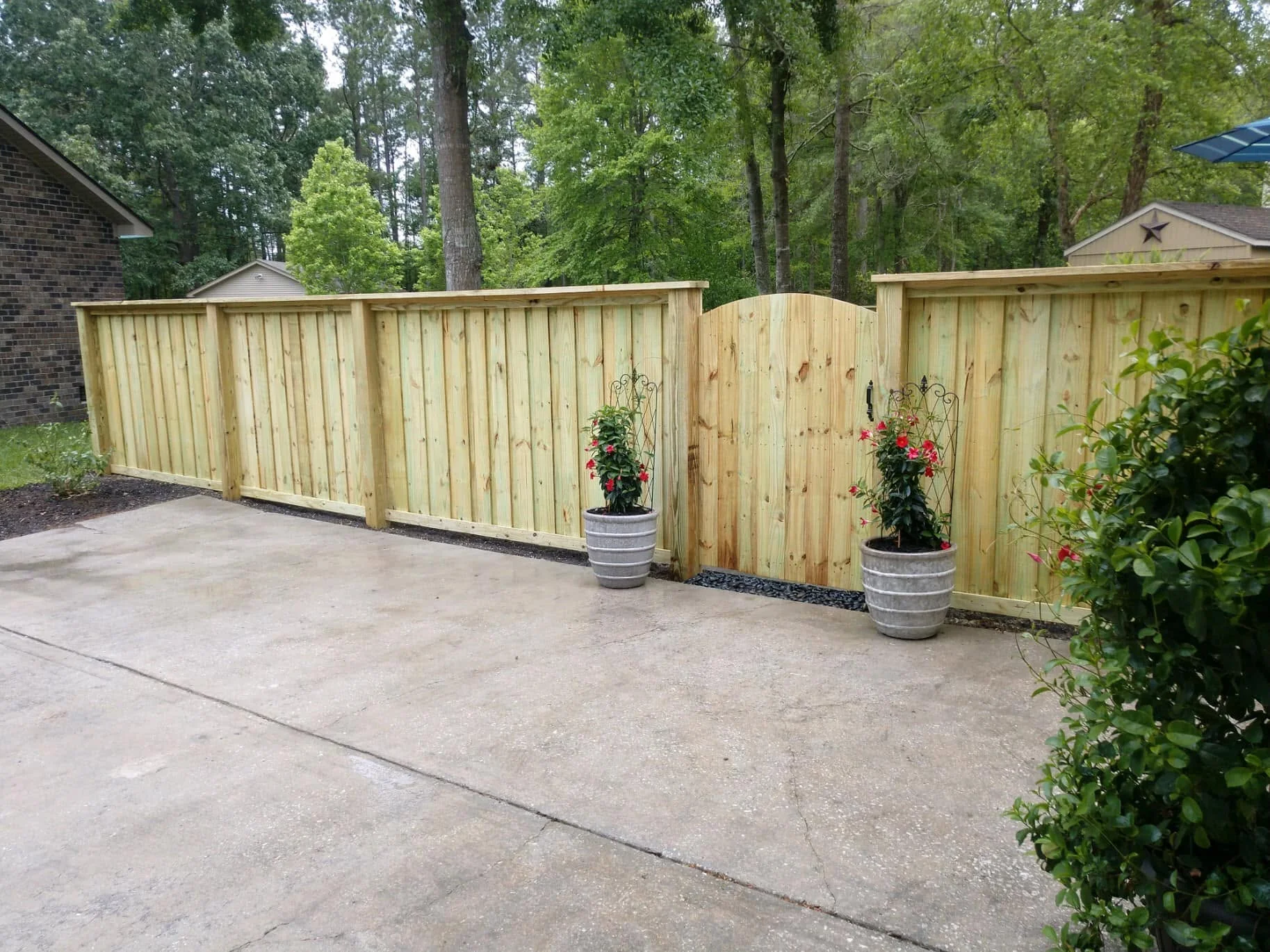 Wood privacy fence with an arched gate