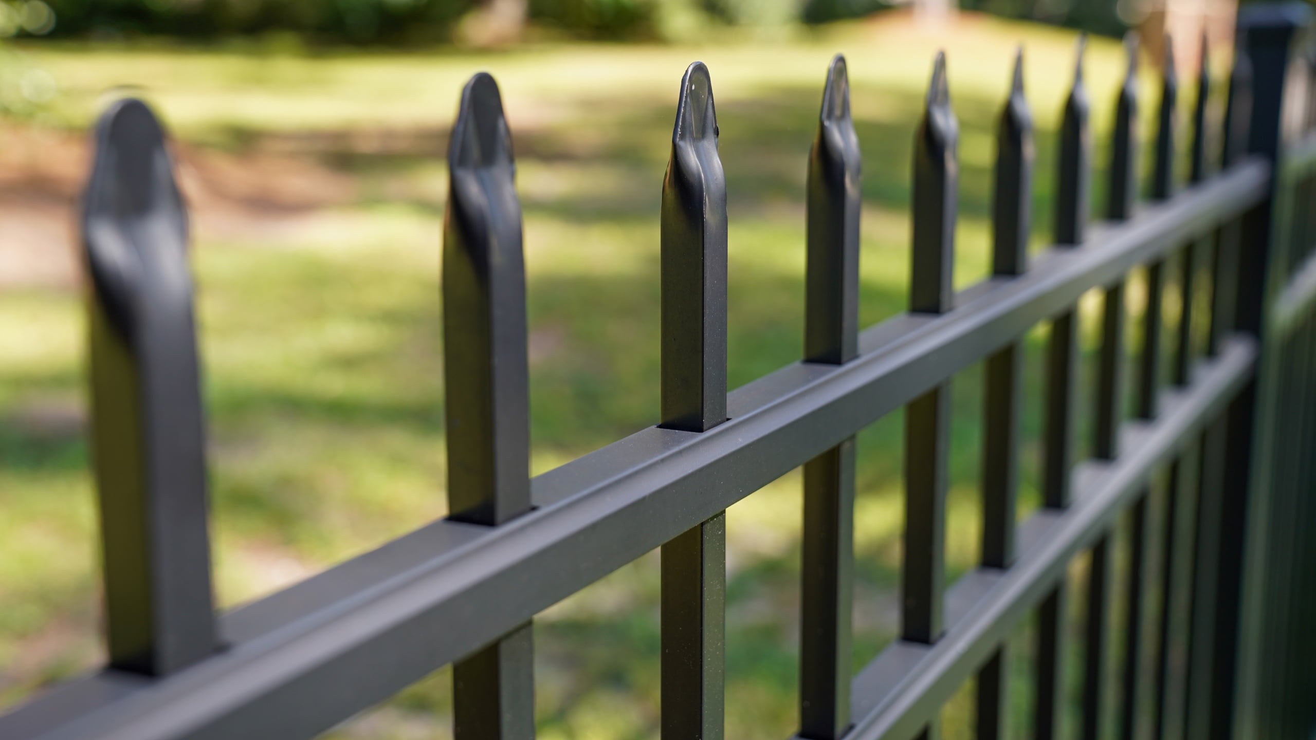 Black ornamental fence with spear-top pickets installed by Floyd Fence